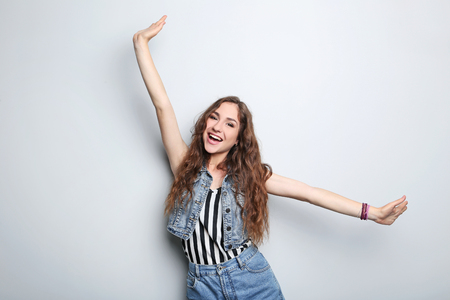 Portrait of young woman on grey backgroundの写真素材