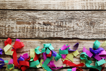 Colored confetti on a grey wooden tableの写真素材
