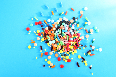 Different colorful pills on blue backgroundの写真素材