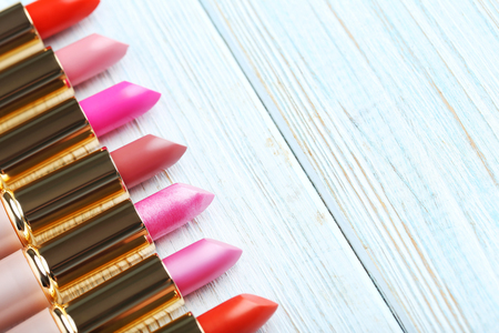Colorful lipsticks on blue wooden tableの写真素材