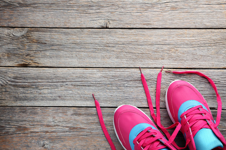 Sport shoes on grey wooden tableの写真素材