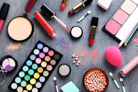 Different makeup cosmetics on grey wooden tableの写真素材