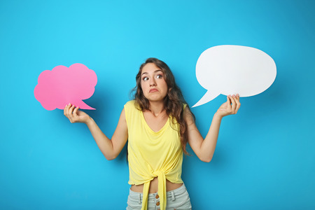 Young woman with speech bubble on blue background