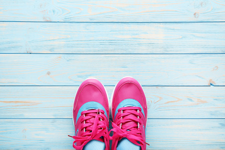 Pink sport shoes on blue wooden tableの写真素材