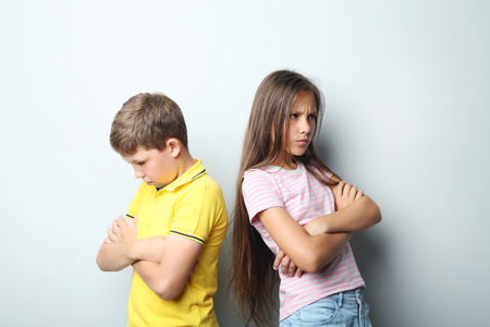 Sad children on grey backgroundの写真素材