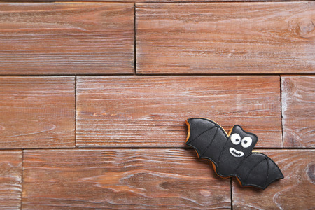 Fresh halloween gingerbread cookies on brown wooden tableの写真素材