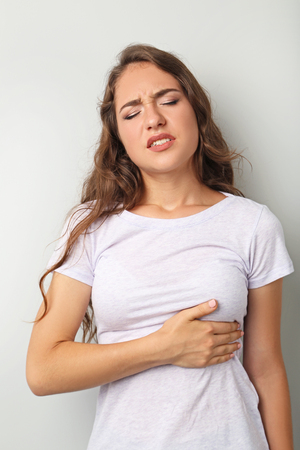 Young woman having heart attackの写真素材