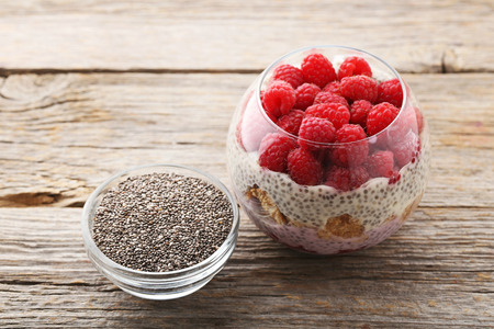 Chia pudding with berries in glass on wooden tableの写真素材