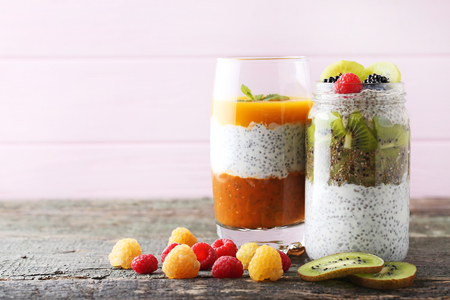 Chia pudding with berries in glass on wooden tableの写真素材