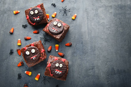Fresh halloween cookies with candy corns on grey wooden tableの写真素材