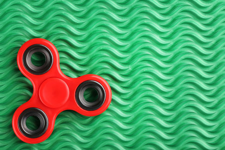 Fidget spinner toy on green backgroundの写真素材