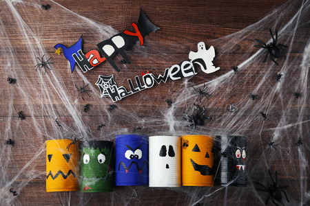 Halloween monsters with spiders and web on brown wooden tableの写真素材