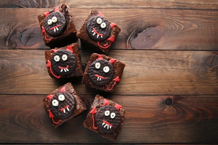 Fresh halloween cookies on brown wooden tableの写真素材