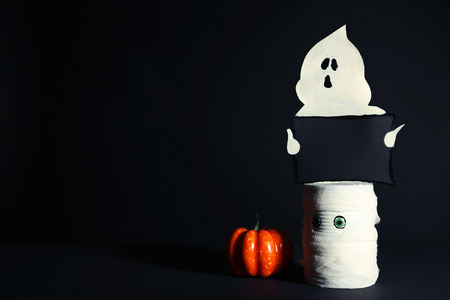 Halloween ghost with pumpkin on black backgroundの写真素材