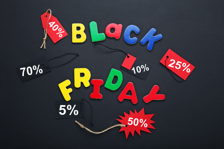 Inscription Black Friday by colourful letters with sale tagsの写真素材
