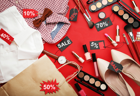 Different makeup cosmetics with sale tags and new clothesの写真素材
