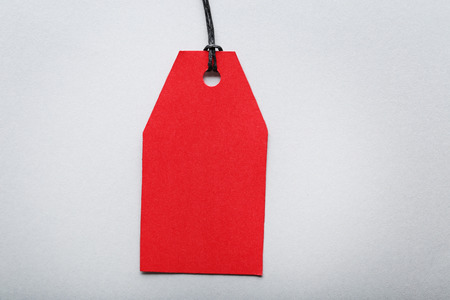 Red sale tag on grey background