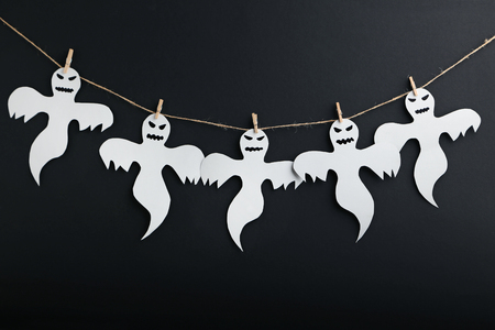 Halloween ghosts hanging on black backgroundの写真素材