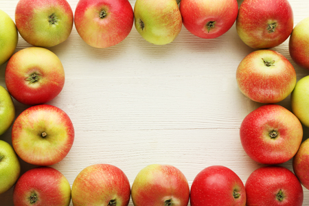 Ripe and sweet apples on wooden tableの写真素材