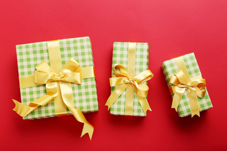 Gift boxes with ribbon on red backgroundの写真素材