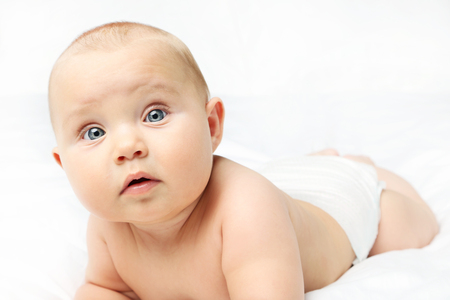 Little newborn baby on white bedの写真素材