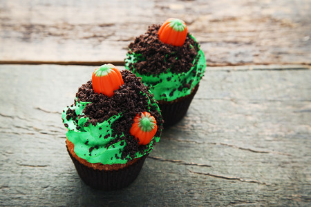 Halloween cupcakes on wooden tableの写真素材