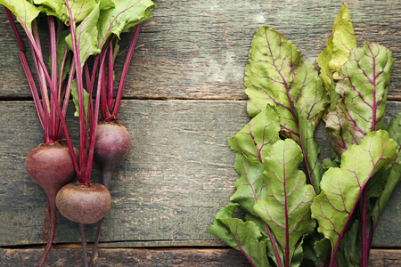Fresh and ripe beets on wooden tableの写真素材