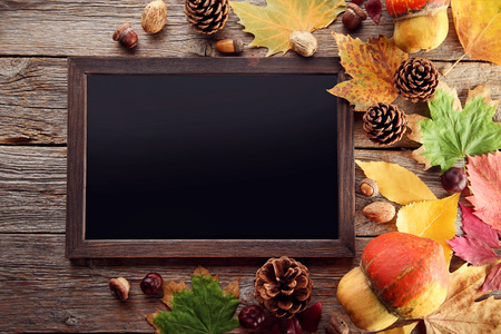 Autumn leafs with black wooden frame on grey table