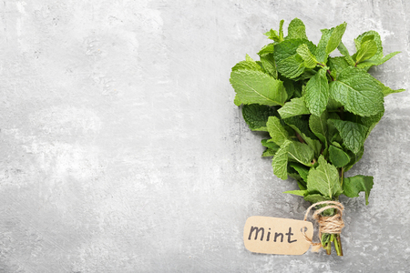 Fresh mint leafs on grey wooden tableの写真素材