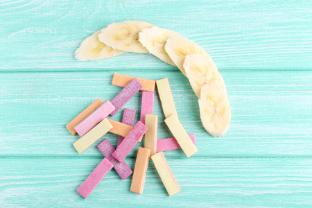 Different chewing gums with banana on mint backgroundの写真素材