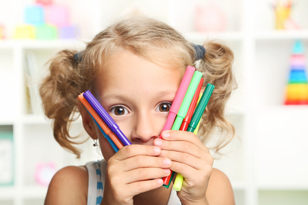 Little girl with colourful felt-pensの写真素材