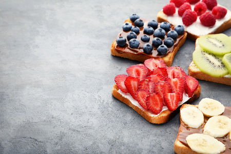 Toasts bread with berries on grey wooden tableの写真素材