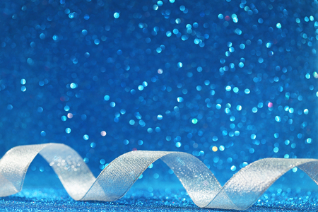 Silver ribbon on blue lights backgroundの写真素材
