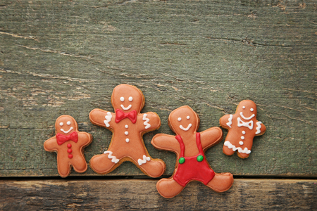 Christmas gingerbread cookies on grey wooden table