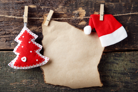 Christmas decorations with blank sheet of paper hanging on ropeの写真素材