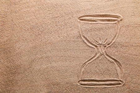 Hourglass drawn on beach sand