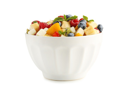 Fresh fruit salad in bowl isolated on whiteの写真素材