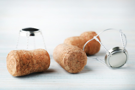 Champagne corks with caps on blue wooden tableの写真素材