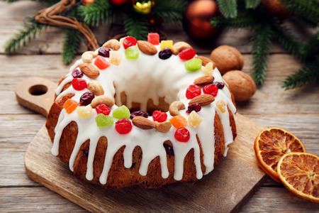Bundt cake with dried oranges on cutting wooden boardの写真素材