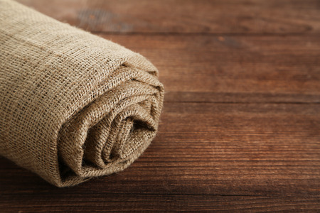 Rolled up sackcloth on brown wooden table
