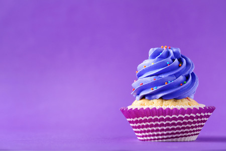 Tasty cupcake on a purple backgroundの写真素材