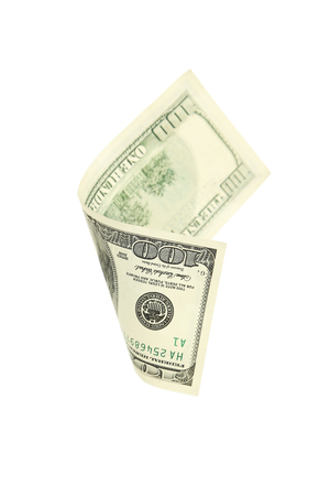 Hundred dollar bill falling on white background