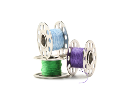 Colourful thread spools isolated on a whiteの写真素材