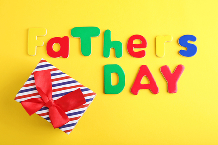 Fathers day words with gift box on yellow backgroundの写真素材