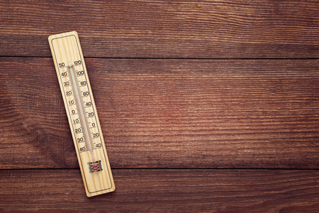 Wooden thermometer on brown tableの写真素材