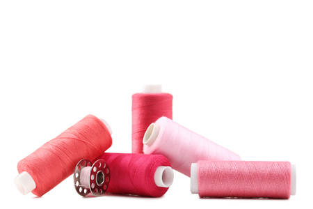 Red thread spools isolated on a whiteの写真素材