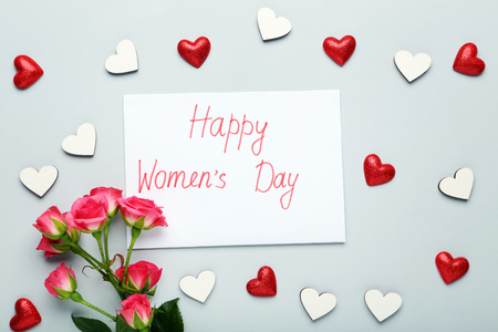 Inscription Happy Women's Day with flowers on grey backgroundの写真素材