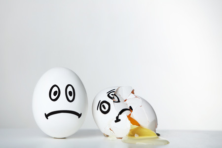 Eggs with funny faces on grey backgroundの写真素材