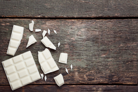 White chocolate pieces on grey wooden tableの写真素材