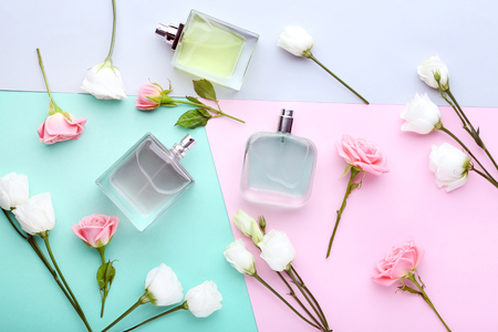 Perfume bottles with flowers on colorful backgroundの写真素材